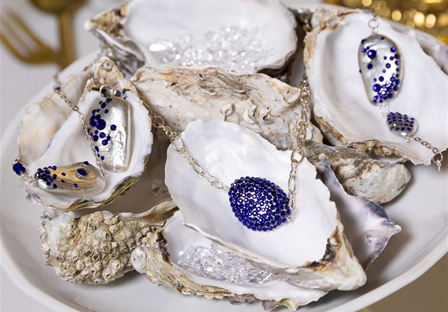 Silver necklace with cobalt blue crystals showcased on oyster shells
