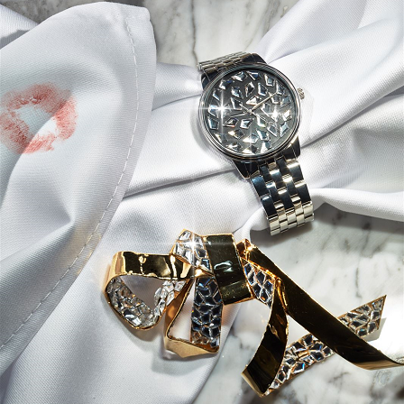 wristwatch adorned with kite flatback crystal on a table